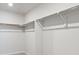 Spacious walk-in closet with shelving and chrome hanging racks for optimal storage at 1401 Bloom St, Brighton, CO 80601