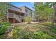 Spacious backyard featuring a wooden deck, patio, shade trees, and a well-maintained lawn at 2732 Flint Ct, Superior, CO 80027