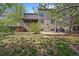 Landscaped backyard featuring a wooden deck, garden, patio, and shade trees at 2732 Flint Ct, Superior, CO 80027