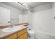 A bathroom with a sink, vanity, toilet, and tiled shower/bathtub combo at 2732 Flint Ct, Superior, CO 80027
