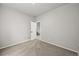 An empty bedroom with carpet and an open door, showing the stairs outside at 2732 Flint Ct, Superior, CO 80027