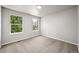 Bright bedroom featuring neutral carpet, light gray walls, and natural light from two windows at 2732 Flint Ct, Superior, CO 80027