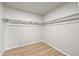 A walk-in closet featuring built-in shelving and light wood-look floors at 2732 Flint Ct, Superior, CO 80027