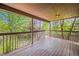Wooden deck with a covered area, offering a relaxing outdoor living space with views of the greenery at 2732 Flint Ct, Superior, CO 80027