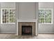 The fireplace in the living room has light colored tiles and a white mantel between two large windows at 2732 Flint Ct, Superior, CO 80027