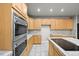 This kitchen has an island with cooktop and offers plenty of cabinets, stainless appliances, and tile backsplash at 2732 Flint Ct, Superior, CO 80027