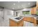 This is a kitchen with a large central island, tile countertops, and abundant cabinet space at 2732 Flint Ct, Superior, CO 80027