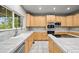 The kitchen has stainless steel appliances, tile countertops, light wood cabinets and a great view out the window at 2732 Flint Ct, Superior, CO 80027