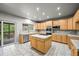 Spacious kitchen featuring tile countertops, stainless steel appliances, a kitchen island and light wood cabinets at 2732 Flint Ct, Superior, CO 80027