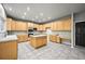 Bright and open kitchen with a large island, tile countertops, and plenty of cabinet space at 2732 Flint Ct, Superior, CO 80027