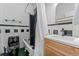 Compact bathroom with black toilet, black and white tiled walls, claw foot tub, and wood vanity at 1356 N Pearl St # 202, Denver, CO 80203