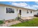 Cozy home exterior displaying a well-kept lawn, concrete steps and a small deck leading to the front door at 13388 Alcott Cir, Broomfield, CO 80020