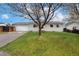 Inviting single-story home featuring a lush green lawn and a mature tree in the front yard at 13388 Alcott Cir, Broomfield, CO 80020