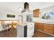 Well-lit kitchen with a central island, offering ample cooking space and view of the backyard at 13388 Alcott Cir, Broomfield, CO 80020