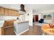 Open kitchen with a functional island, wooden cabinets, and seamlessly connects to the living area at 13388 Alcott Cir, Broomfield, CO 80020