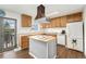 Well-lit kitchen featuring white appliances, a wooden island, and ample cabinet space for storage at 13388 Alcott Cir, Broomfield, CO 80020