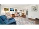 Bright living room with hardwood floors, comfortable seating, and a decorative area rug at 13388 Alcott Cir, Broomfield, CO 80020