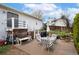 An inviting outdoor patio with dining and seating areas, a grill, and serene views of the garden at 13388 Alcott Cir, Broomfield, CO 80020
