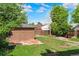A large, green backyard shows the yard and a brick shed on the property at 2271 Holly St, Denver, CO 80207