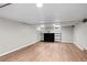 Finished basement featuring wood floors, a fireplace, built-in shelving and windows at 2271 Holly St, Denver, CO 80207