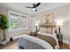 Cozy bedroom with neutral tones, a ceiling fan, and two windows for ample natural light at 2271 Holly St, Denver, CO 80207