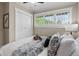 Bedroom featuring a closet, large windows, and a queen-sized bed with decorative pillows and throws at 2271 Holly St, Denver, CO 80207