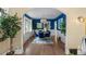 Dining room with blue accent wall and hardwood flooring at 2271 Holly St, Denver, CO 80207