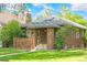 The brick home's exterior shows the sidewalk and surrounding lawn at 2271 Holly St, Denver, CO 80207