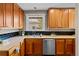Well-lit kitchen with wood cabinets, granite countertops, subway tile backsplash, and stainless steel appliances at 2271 Holly St, Denver, CO 80207