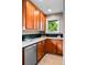 Well-equipped kitchen features wood cabinets, granite countertops, subway tile backsplash, and stainless steel appliances at 2271 Holly St, Denver, CO 80207