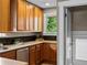 Functional kitchen boasts wood cabinets, granite countertops, subway tile backsplash, and stainless steel appliances at 2271 Holly St, Denver, CO 80207