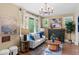 Bright and airy living room features a decorative fireplace, lots of natural light, and hardwood floors at 2271 Holly St, Denver, CO 80207