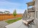 A spacious backyard with a concrete patio, seating, a small lawn and a wood fence at 4552 S Perth Ct, Aurora, CO 80015