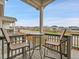 Covered balcony with a small table and chairs overlooking the street and neighborhood at 4552 S Perth Ct, Aurora, CO 80015