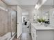 Stylish bathroom featuring a glass shower and double sink vanity at 4552 S Perth Ct, Aurora, CO 80015