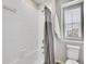 Bright bathroom with a shower-tub and toilet with storage at 4552 S Perth Ct, Aurora, CO 80015