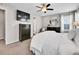 This bedroom features a large TV, ceiling fan, and round mirror at 4552 S Perth Ct, Aurora, CO 80015