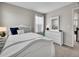 Bright bedroom with a white bed, dresser, and cozy decor at 4552 S Perth Ct, Aurora, CO 80015