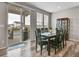 A dining room features a wooden table and chairs, wood floors, and a sliding glass door to the outside deck at 4552 S Perth Ct, Aurora, CO 80015