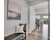 Inviting entryway with bench seating and stylish decor, leading to the open-concept living space at 4552 S Perth Ct, Aurora, CO 80015