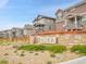 Community entrance with a stone sign that reads 'Alder' surrounded by gravel and bushes at 4552 S Perth Ct, Aurora, CO 80015