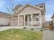 Beautiful two-story home features a cozy front porch and mature trees at 4552 S Perth Ct, Aurora, CO 80015