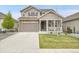 Charming two-story home features a welcoming front porch and a well-maintained lawn at 4552 S Perth Ct, Aurora, CO 80015
