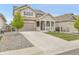 Inviting two-story home showcases a spacious driveway and manicured landscaping at 4552 S Perth Ct, Aurora, CO 80015