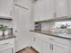 Kitchen counter shows white cabinets, gray countertops, and stainless steel appliances at 4552 S Perth Ct, Aurora, CO 80015