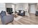 Comfortable living room featuring plush seating, a modern entertainment center, and ample natural light at 4552 S Perth Ct, Aurora, CO 80015