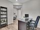 Functional home office featuring a spacious desk, built-in shelving, and a comfortable chair at 4552 S Perth Ct, Aurora, CO 80015