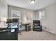 Home office space featuring a large desk, chair, and comfortable recliner at 4552 S Perth Ct, Aurora, CO 80015