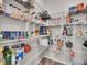 Walk-in pantry with ample shelving, and storage for food items and kitchen essentials at 4552 S Perth Ct, Aurora, CO 80015