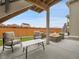 Back patio with an outdoor seating area with a table and chairs and a built-in fire pit at 4552 S Perth Ct, Aurora, CO 80015